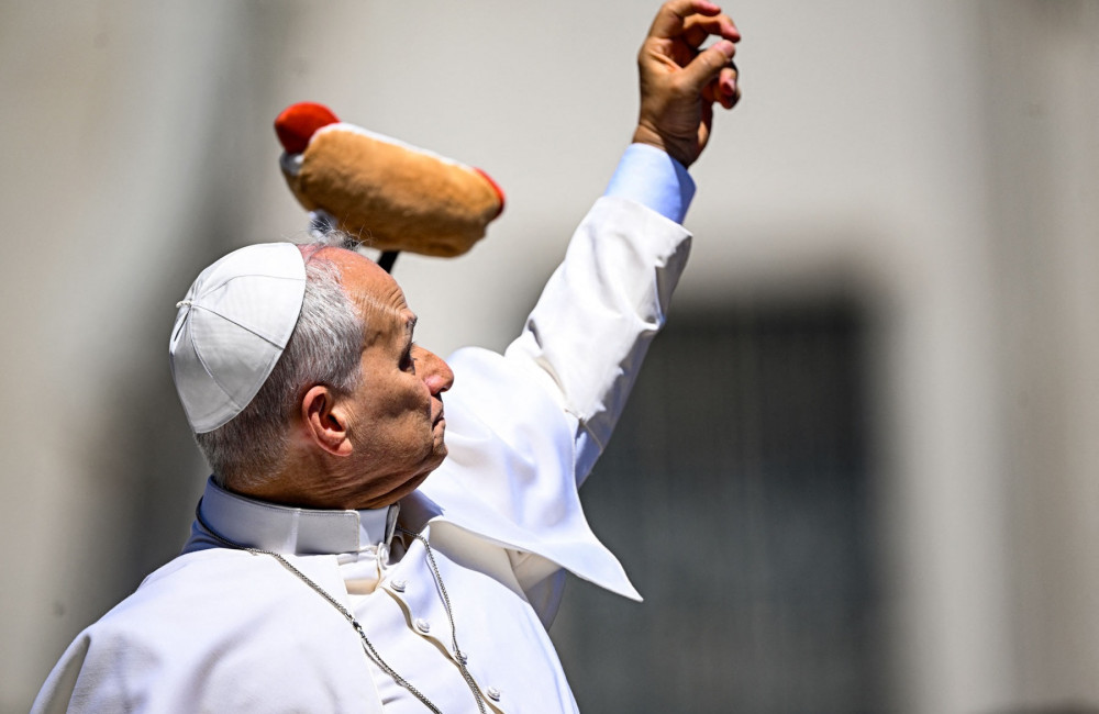 Pope Leo tries to catch hot dog toy from crowd